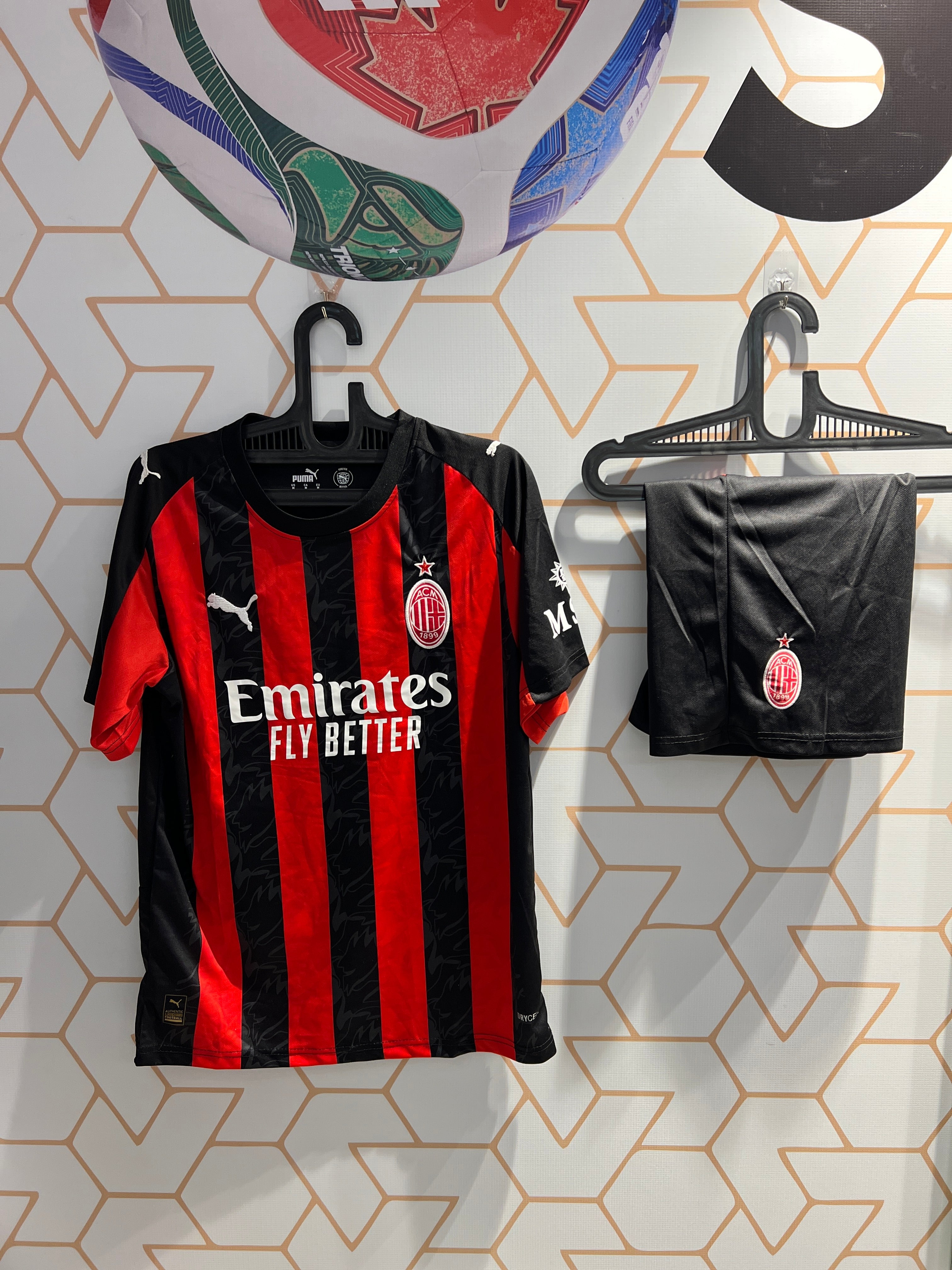 AC Milan 25/26 Home Kit front view red and black football jersey with shorts
