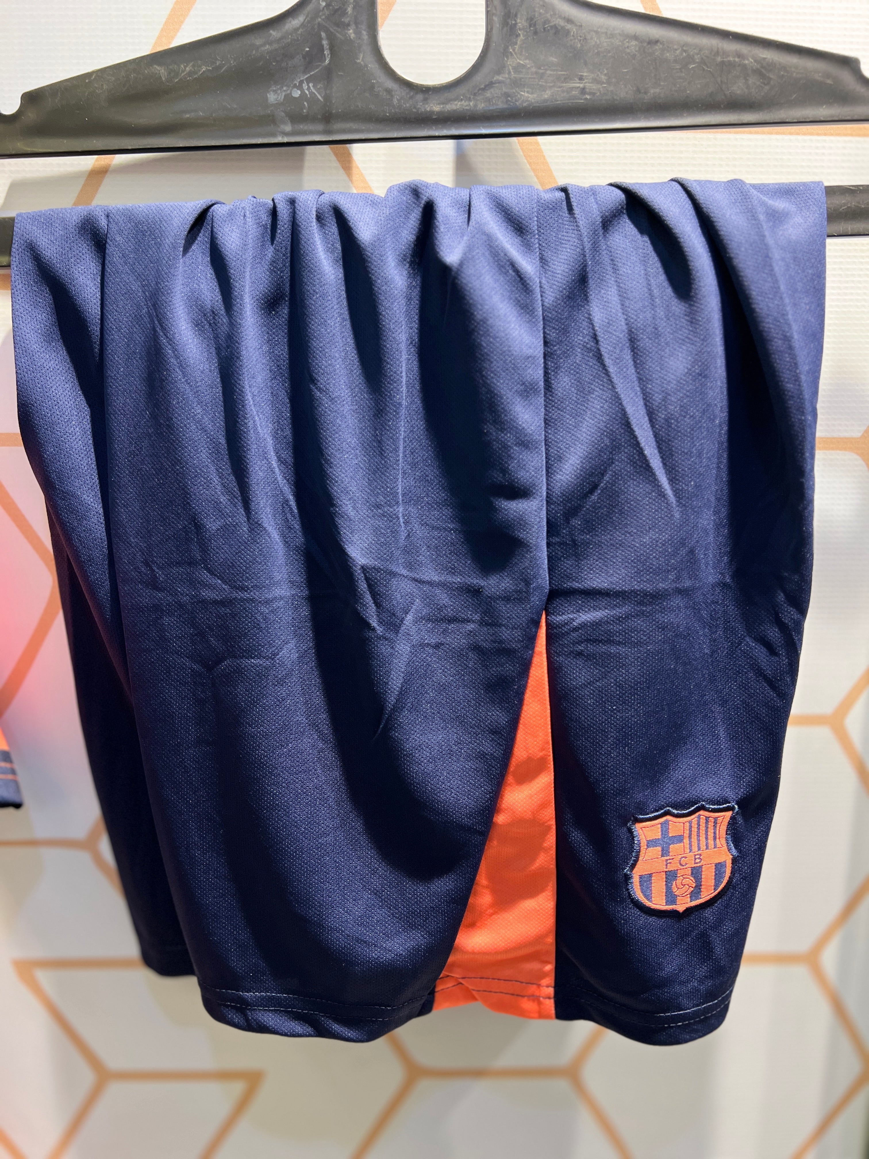 Player wearing FC Barcelona Away Orange 25/26 Kit during football training