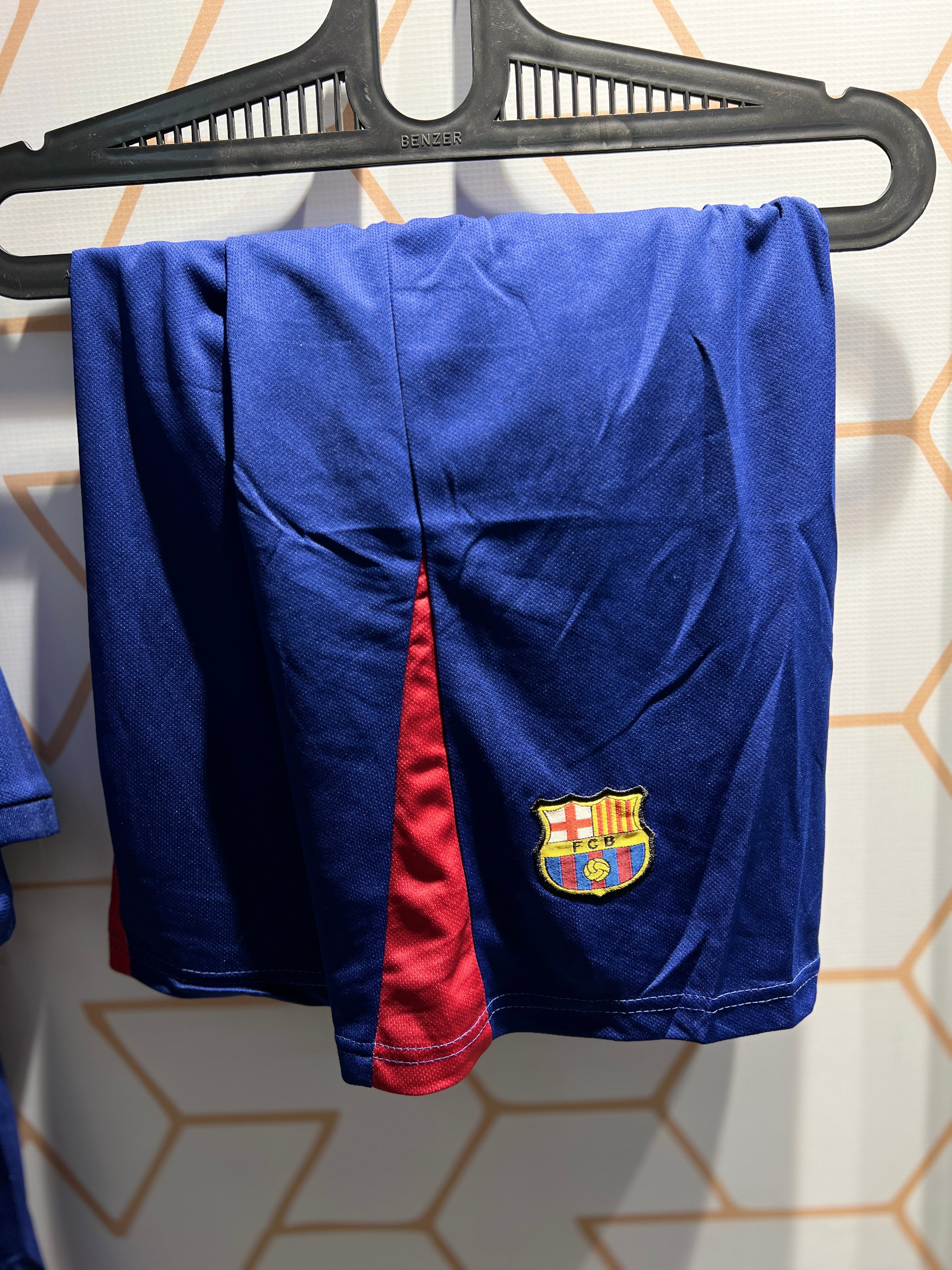 Player wearing FC Barcelona Home 25/26 Kit during football match blue and red design