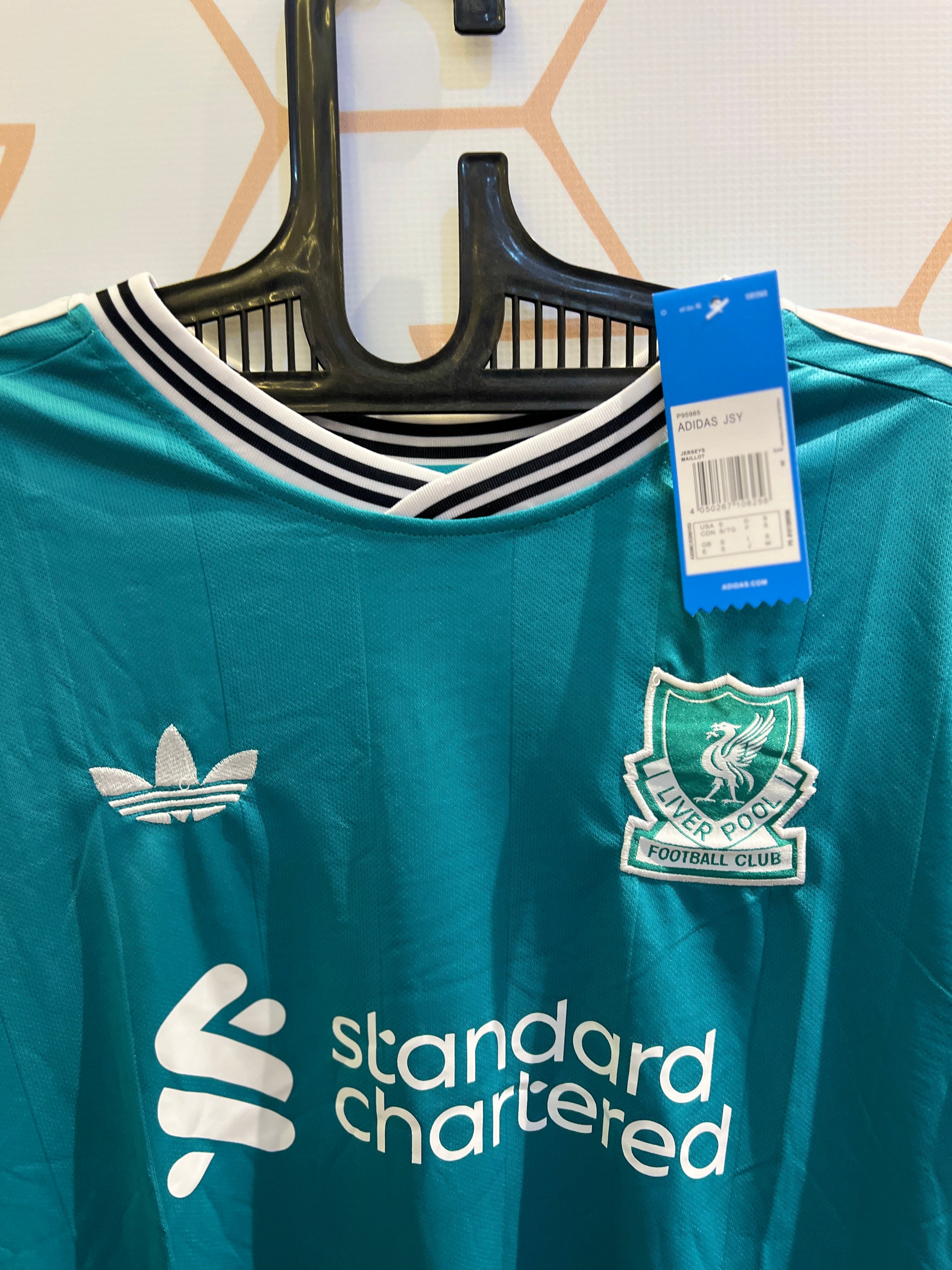 Close-up of Liverpool FC Away 25/26 Kit fabric design and club crest