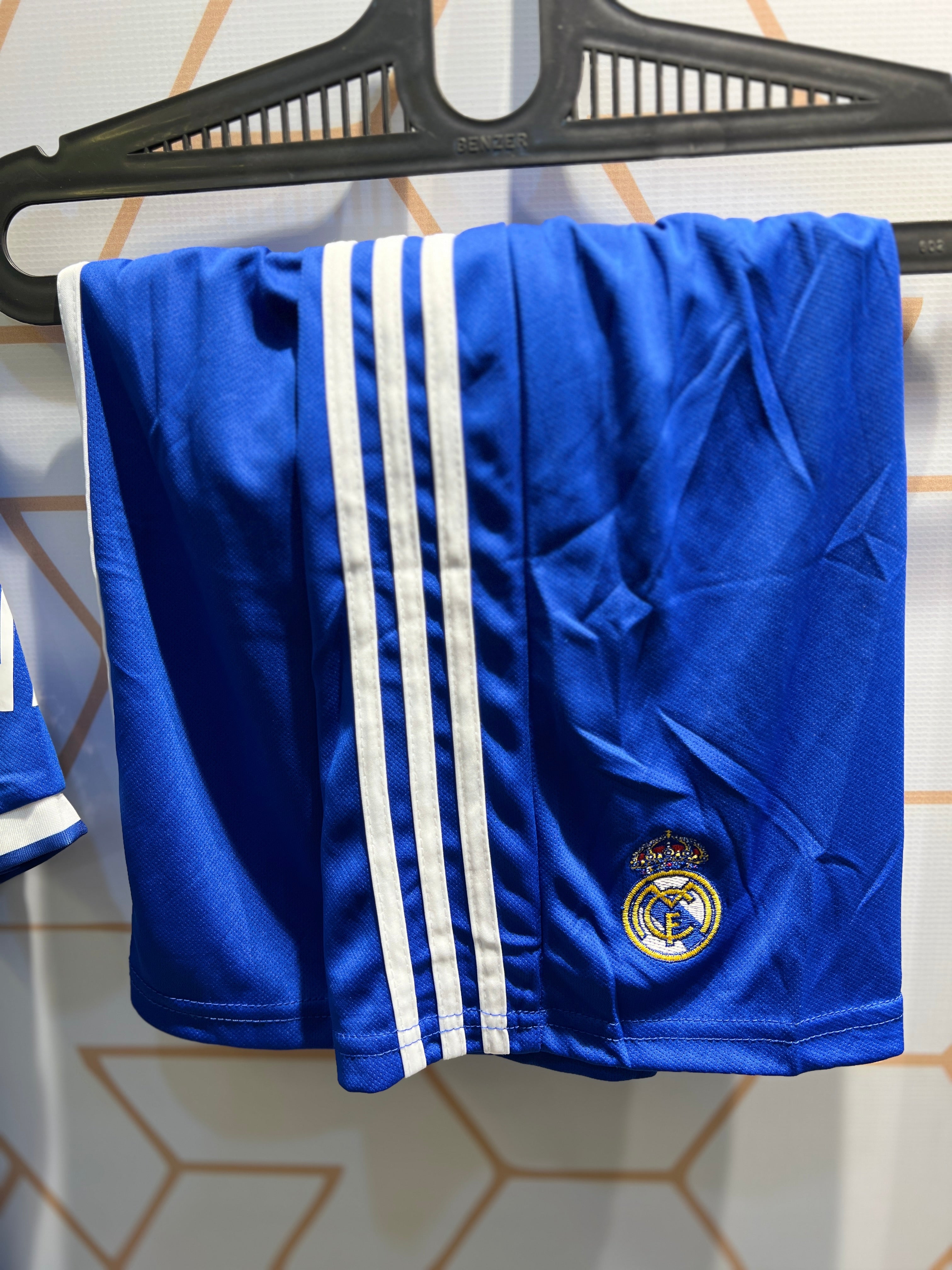 Player wearing Real Madrid Away 25/26 Kit during football match