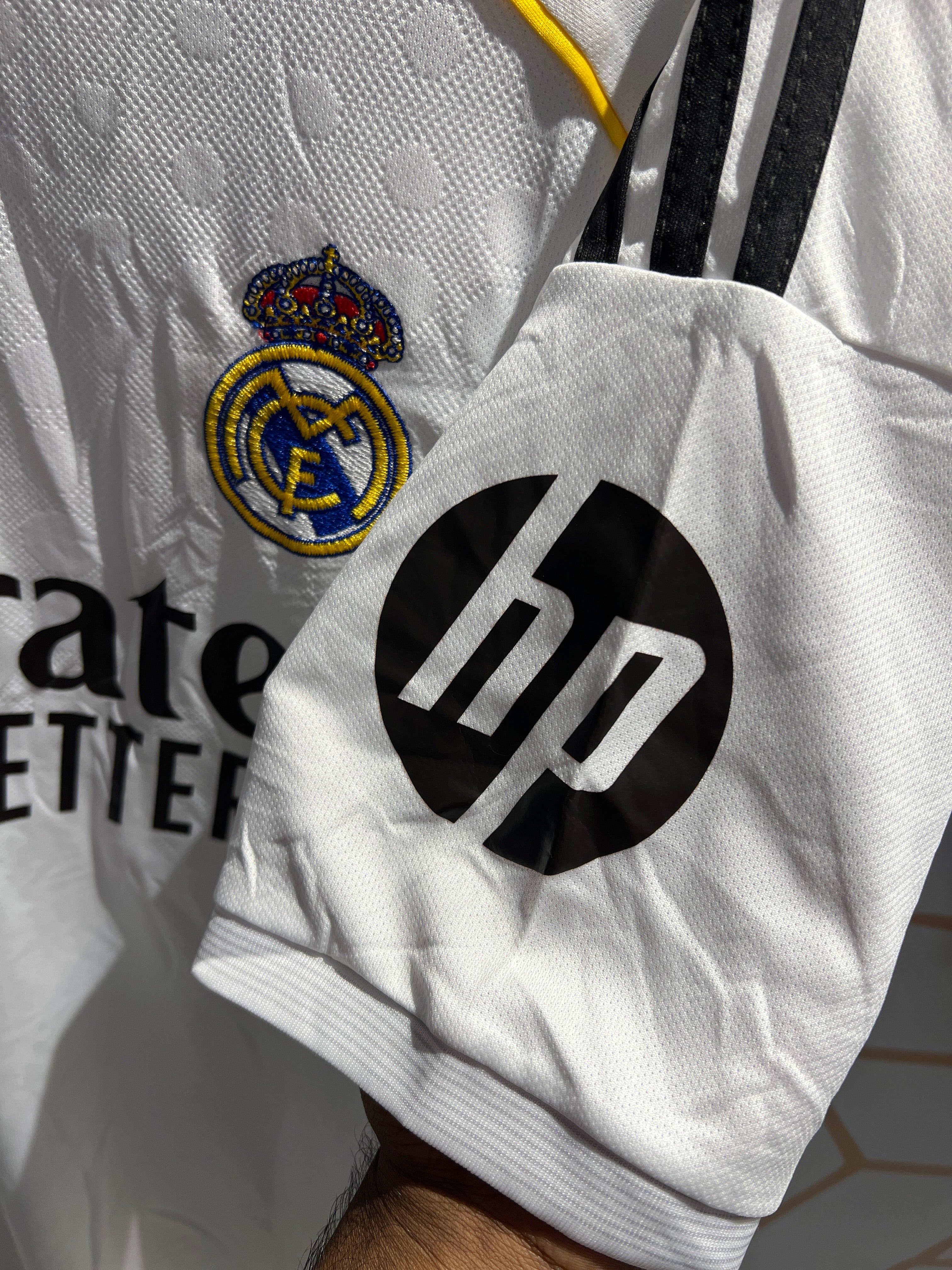 Close-up of Real Madrid Home 25/26 Kit fabric texture and club crest detail